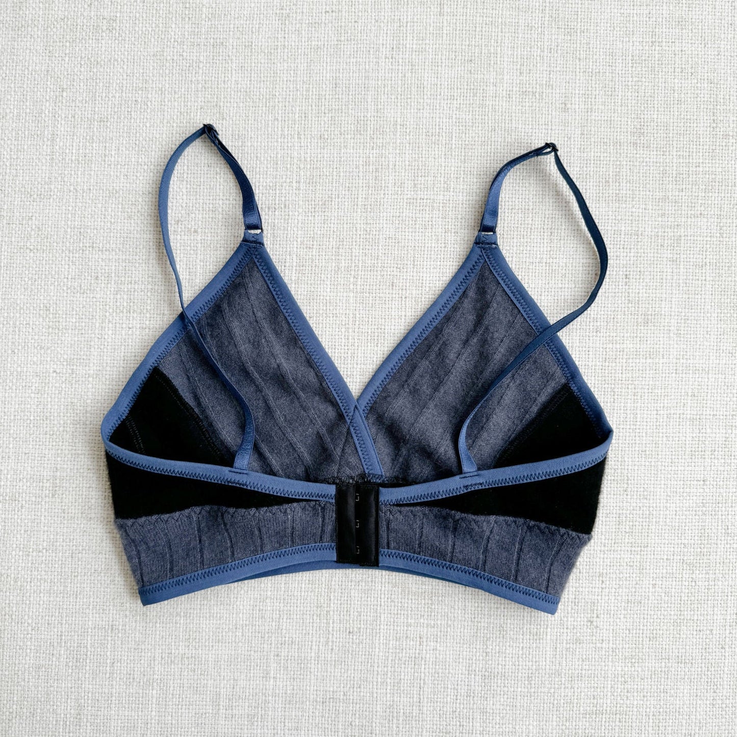 100% cashmere long bra top, classic Black with Dusty Blue highlights, made by Econica, Canadian craftsmanship, luxurious feel, sophisticated color combination, handcrafted with care, sustainable luxury, comfortable fit, modern design, natural insulation, artisanal fashion