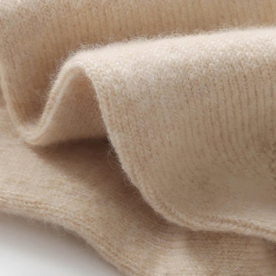 Close-up of beige fabric with a textured pattern on a white background
