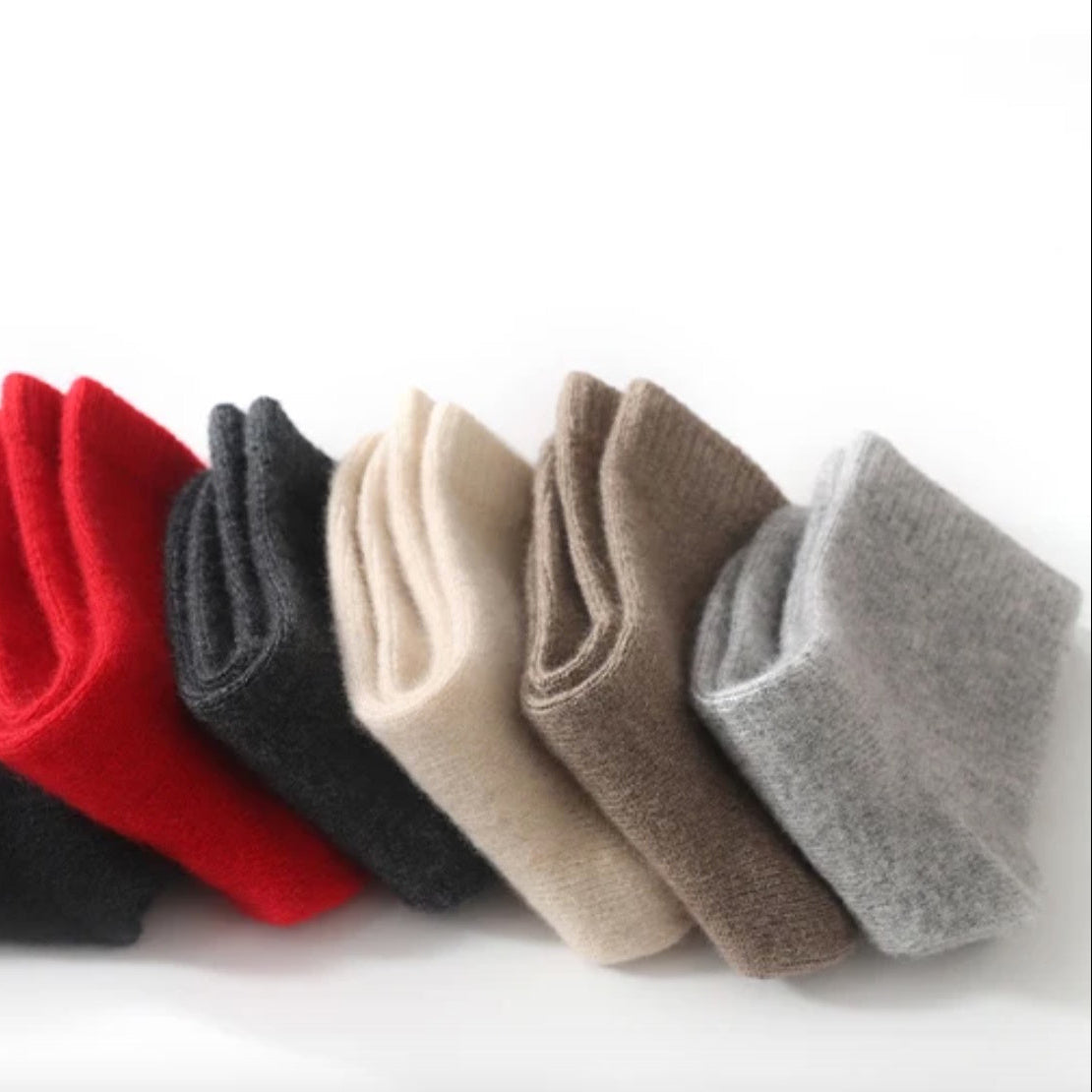 Set of five pairs of socks in black, red, gray, beige, and brown on a white background