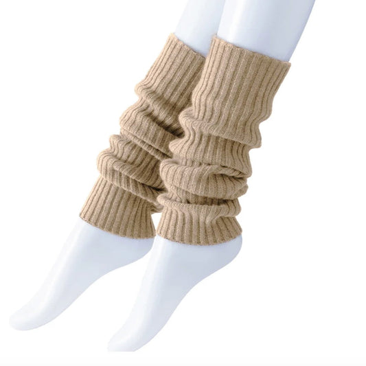 Beige ribbed leg warmers worn over white socks on a white background