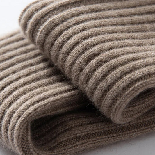Close-up of a folded brown knitted fabric on a white background